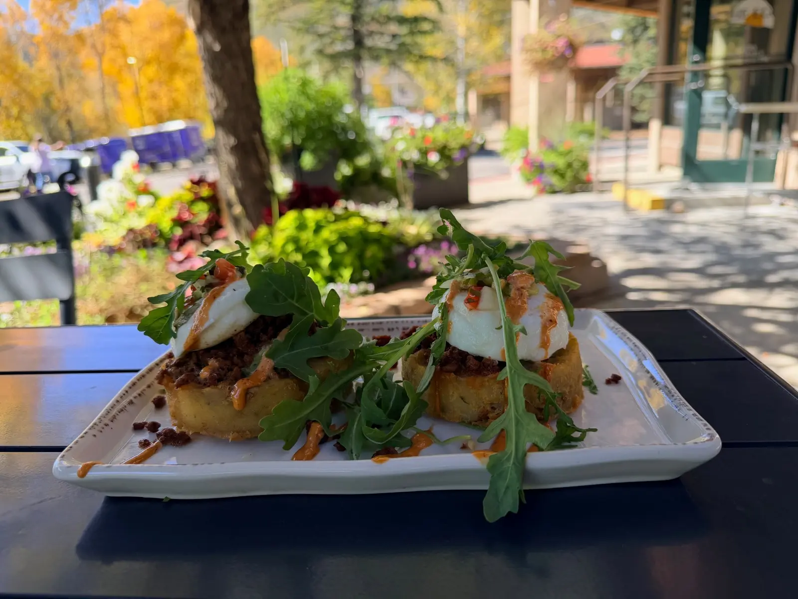 Rabbit Ears Benedict with potato nests, poached eggs, chorizo, arugula, and chipotle aioli